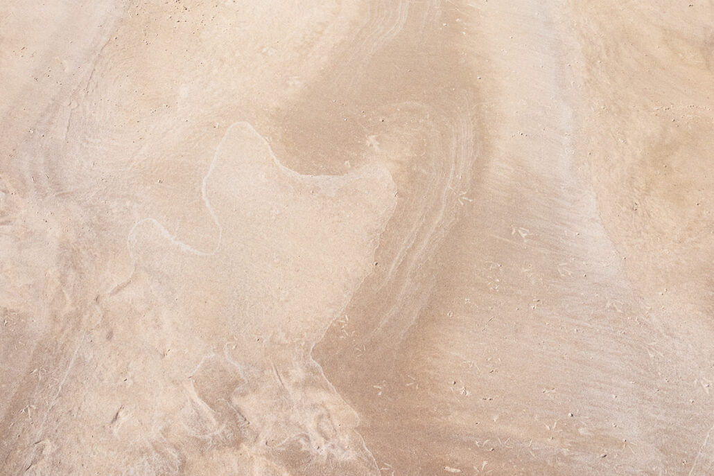 Water Marks and patterns left on sand by the surf and tide. Photograph by Jeff Kauffman (#0116)