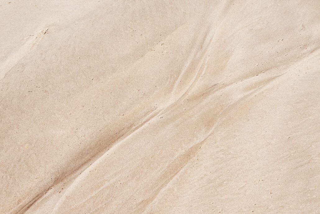 Water Marks and patterns left on sand by the surf and tide. Photography by Jeff Kauffman (#0011)