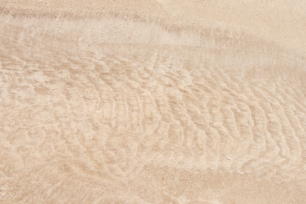 Water Marks and patterns left on sand by the surf and tide. Photograph by Jeff Kauffman (#0043)