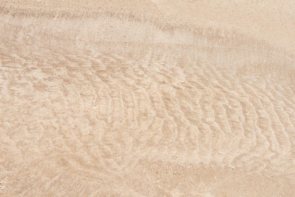 Water Marks and patterns left on sand by the surf and tide. Photograph by Jeff Kauffman (#0043)