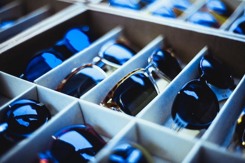 Photo of a retail display case filled with luxury sunglasses. 