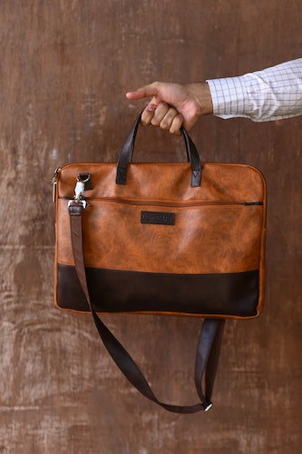 Photo of luxury leather briefcase in brown with black trim.