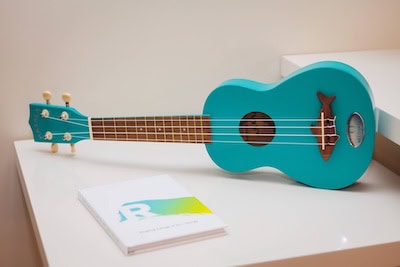 A ukelele and a sketch book in a guest room at the Art Ovation hotel, and art hotel in Sarasota, Florida. Photo courtesy of Expedia.com