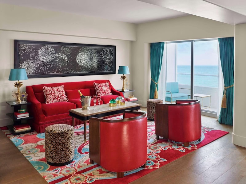 Photo of a room suite at the Faena Hotel Miami Beach showing a balcony and red furniture. Photo courtesy of Expedia.com.