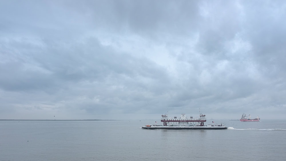 A ferry boat crosses Galveston Ship Channel on a cloudy day. Photo ©Jeff Kauffman.